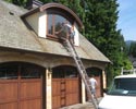 man on a latter cleaning windows